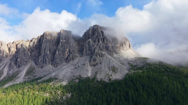 Stunning aerial perspective of the Croda da Lago peaks with clouds rolling over the ridges
