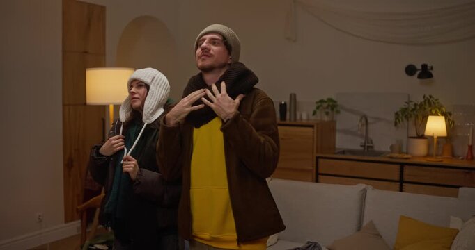 Couple Checking Their Winter Outfits in Mirror Before Going Out