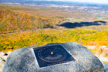 Raven’s Roost  plaque overlooking colorful Virginia hills on Blue Ridge Parkway