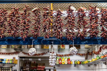 Hungary. Budapest. Chili peppers hanging in a shop at the market.