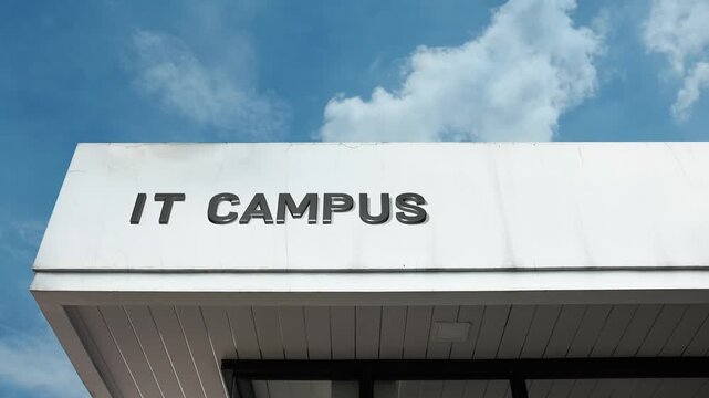 IT Campus word sign displayed on building facade under clear blue sky, representing technology education, software development training, and information technology specialization
