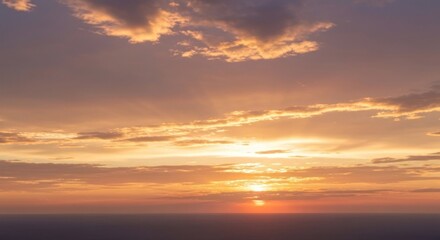 Sea sunset with radiant golden light piercing clouds over a calm sea