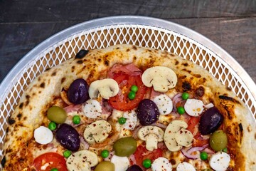 The most authentic Brazilian rustic pizza, with vegetables and ham. Homemade artisanal pizza baked in a wood-fired oven. The most perfect pizza in the world.