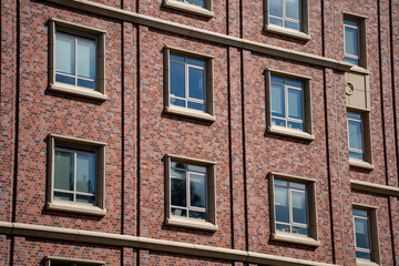 Rows of windows in red brick facade