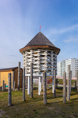 A modern eco-style playground stylized as an ancient wooden fortress. The concept of integrating a play area into a historic urban environment, creating a unique recreational space.
