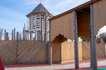 A modern eco-style playground stylized as an ancient wooden fortress. The concept of integrating a play area into a historic urban environment, creating a unique recreational space.