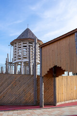 A modern eco-style playground stylized as an ancient wooden fortress. The concept of integrating a play area into a historic urban environment, creating a unique recreational space.