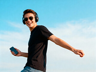 Young man wearing headphones and sunglasses enjoying outdoor music