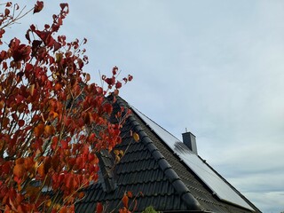 Solar panels on house roof in autumn season
