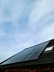 Solar panels generating clean energy on house roof