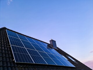 Solar panels providing clean energy on house roof