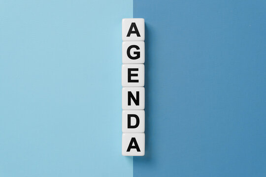 Agenda word on dice on blue and gray background