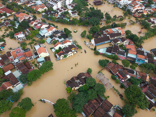  The deepest flood in history in Hoi An, Da Nang 2025. Aerial view of flooded ancient Asian town with yellow houses and brown roofs, showing severe urban flooding and climate disaster impact