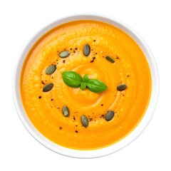 Creamy orange soup in white bowl, garnished with seeds and herbs