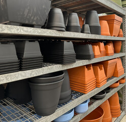 A variety of planters for sale on metal shelves