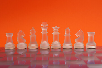 Row of chess pieces on a chessboard, symbolizing strategy, leadership, and clear thinking in business or decision-making © Myrarte