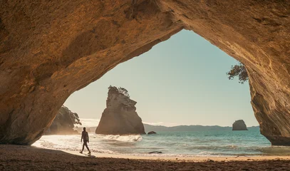 Keuken achterwand Cathedral Cove Traveler in cave at Cathedral Cove, New Zealand at sunrise  © Louis Letort