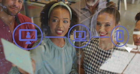 Five coworkers in business casual attire planning at office glass wall, reviewing flowchart icons