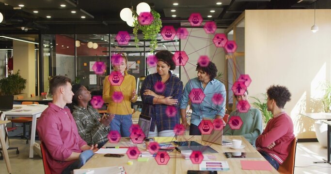 Discussing professional team working around table in conference room, with pink digital overlay