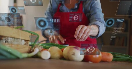 Mature woman tapping holographic UI on countertop and chopping green onions for smart meal tracking
