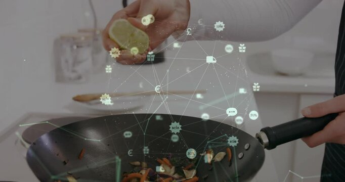 Woman in food tech gripping wok squeezing lime juicing veggies as digital icons shifting above wok
