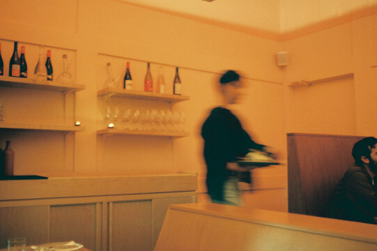 Warm Restaurant Scene with Blurry Server