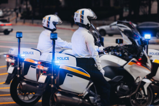 Korean traffic police squad formation on the road, riding bike and motorcycle, highway patrol maintain public order in the city streets of Seoul, South Korea, policemen motorbikes with sirens pursuit - Powered by Adobe