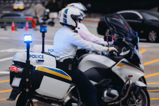 Korean traffic police squad formation on the road, riding bike and motorcycle, highway patrol maintain public order in the city streets of Seoul, South Korea, policemen motorbikes with sirens pursuit
