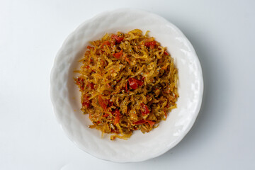 sambal teri, a popular Indonesian condiment made from crispy anchovies and a spicy chili paste, serve on white plate