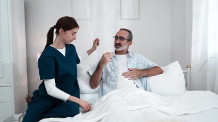 young nurse in uniform takes care of an elderly man, holding his hand and asking him about his condition and giving him encouragement. A nurse uses a stethoscope to check his pulse in a nursing home.
 - Powered by Adobe