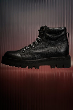 Stylish black hiking boots displayed on a gradient backdrop