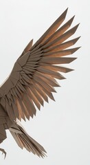 Obraz premium Intricately folded paper sculpture depicts a bird of prey with outstretched wings against a bright backdrop