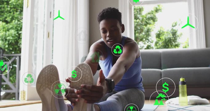 Fitness trainee on yoga mat initiating hamstring stretch by hinging hips with floating energy icons