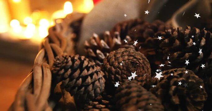 Camera focusing burlap-wrapped pine cones in basket, star lights drifting highlighting candle glow