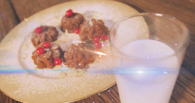 Sparkles drifting over chocolate bundt cakes dusted with sugar, camera panning to reveal milk glass