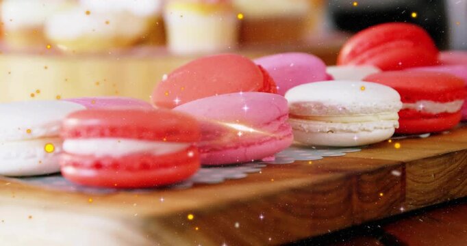 Colorful macarons on wooden board, sparkles drifting and lens flare sweeping, enhancing pastel hues