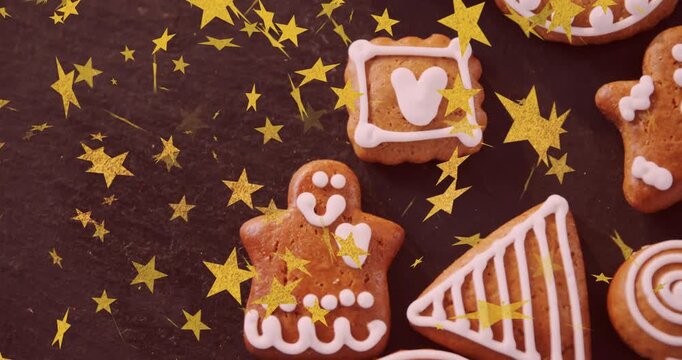 Gold star confetti starting falling over iced gingerbread cookies, creating festive pattern