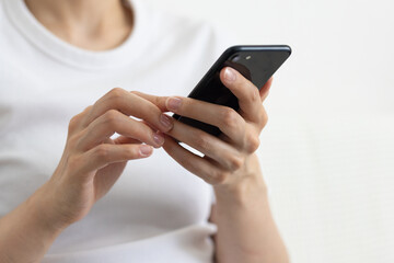 Close-up of smartphone held by woman