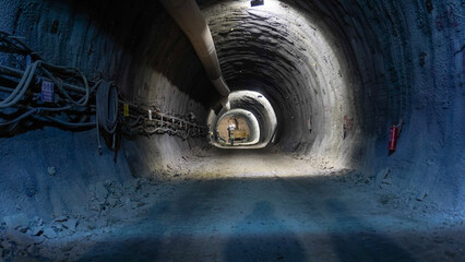 Tunnel Construction: Large Pipe, Cable System, and Distant Machine