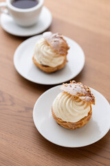 Cream puffs with whipped cream filling on a white plate