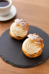Cream puffs with whipped cream filling on a white plate