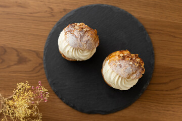Cream puffs with whipped cream filling on a white plate
