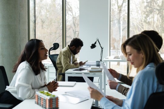 Side of e agent telling to couple clients reading purchase agreement