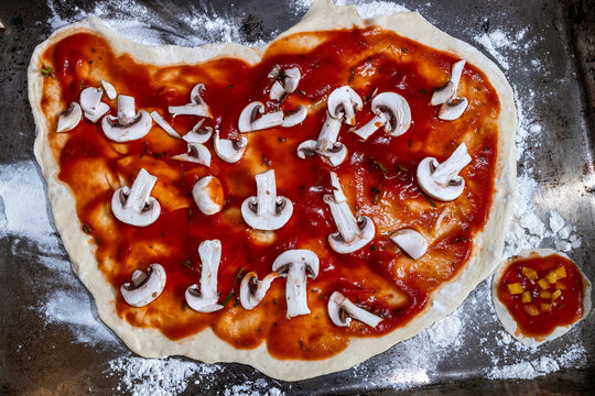 Chopped mushrooms on a pizza base
