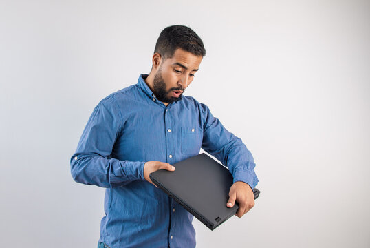 Surprised Man Looking Down at Closed Laptop