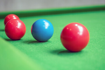 Close up Snooker balls on a green table focus on blue