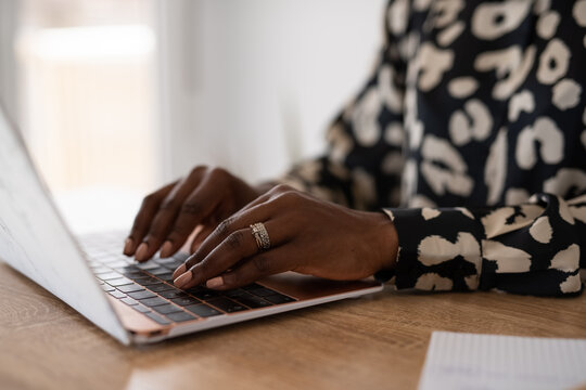 Woman typing on laptop keyboard
