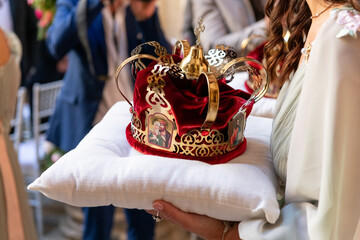 Symbolic religious crown on a pillow during wedding ceremony