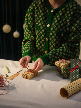 Preparing for the holidays. wrapping Christmas gifts in a cozy setting