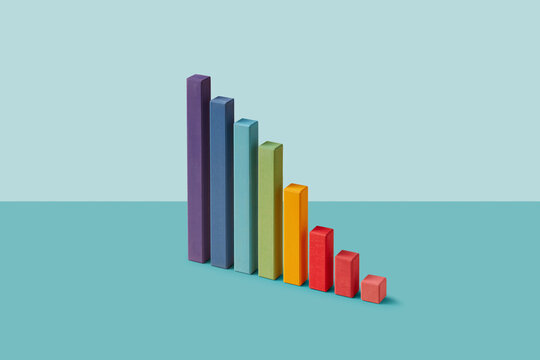 Color wooden blocks as descending chart on teal